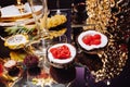 Luxury candy bar on golden wedding. Candy bar decorated by flowers standing of festive table with deserts, and cakes, strawberry Royalty Free Stock Photo