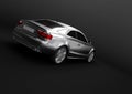 Back-side view of a luxury sedan car in a dark background Royalty Free Stock Photo