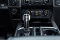 Luxury car interior. Control panel, radio system, shift lever. Automatic transmission gearshift stick. Selective focus Royalty Free Stock Photo