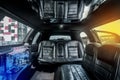 Luxury car interior limousine with black leather seats and a small bar inside the interior of the car