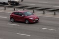 Luxury car red Renault speeding on empty highway