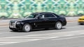 luxury car Rolls-Royce Ghost driving down the road at high speed Royalty Free Stock Photo