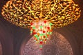 Luxury chandelier hanging on ceiling with lots of little gems.