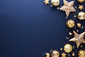 Luxury Christmas flat lay composition. Golden stars, baubles, confetti on dark blue background. Frame of elegant Christmas Royalty Free Stock Photo