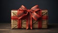 Luxury christmas present wrapped with golden paper. Red ribbon with big bow. Royalty Free Stock Photo