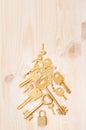 Luxury christmas tree of gold retro keys on soft beige wooden background, copy space. Royalty Free Stock Photo