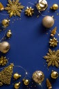 Luxury Christmas vertical banner design. Golden decorations, balls, garland lights, snowflakes on dark blue background. New Year