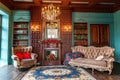 Luxury classic interior of home library. Sitting room with bookshelf, books, arm chair, sofa and fireplace Royalty Free Stock Photo