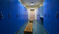 Large blue lockers and wooden bench