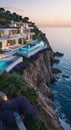 Luxury Cliffside Villa with Infinity Pool Overlooking the Ocean at Sunset Royalty Free Stock Photo