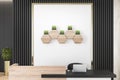 Luxury concrete and wooden office lobby interior with reception desk, laptop, decorative plants and other items. Royalty Free Stock Photo