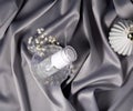 Luxury cosmetics concept. Still life on a shiny delicate gray fabric