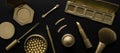 luxury cosmetics - set with golden makeup beauty products on black background