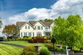 Luxury country home with large green lawn and landscaping in front yard Royalty Free Stock Photo