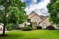 Luxury country home with large green lawn and landscaping in front yard Royalty Free Stock Photo