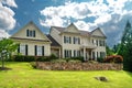 Luxury country home with large green lawn and landscaping in front yard Royalty Free Stock Photo