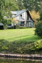 Luxury country retreat with grassland and dam in the foreground