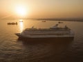 The luxury cruise liner in a port near big sea city during sunset. Royalty Free Stock Photo