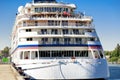 Luxury cruise ship docked in port. Front view of white passenger vessel