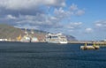 Luxury cruiser in harbor with mountains in background Royalty Free Stock Photo