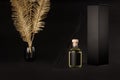 Luxury dark mock up for advertising of cosmetics for home - glass bottle diffuser with perfume and aromatic sticks, golden decor.