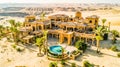 Luxury Desert Villa with Palm Trees in Aerial View