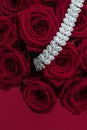 Luxury diamond jewelry bracelet and red roses flowers, love gift on Valentines Day and jewellery brand holiday background design Royalty Free Stock Photo