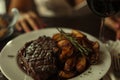 Luxury dinner served on the table with glass of red wine and grilled steak. Generative AI Royalty Free Stock Photo