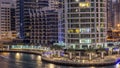 Luxury Dubai Marina canal with passing boats and promenade day to night timelapse, Dubai, United Arab Emirates