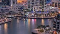 Luxury Dubai Marina canal with passing boats and promenade day to night timelapse, Dubai, United Arab Emirates