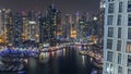 Luxury Dubai Marina canal with passing boats and promenade night timelapse, Dubai, United Arab Emirates Royalty Free Stock Photo