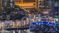 Luxury Dubai Marina canal with passing boats and promenade night timelapse, Dubai, United Arab Emirates Royalty Free Stock Photo