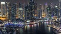 Luxury Dubai Marina canal with passing boats and promenade night timelapse, Dubai, United Arab Emirates Royalty Free Stock Photo