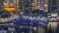 Luxury Dubai Marina canal with passing boats and promenade night timelapse, Dubai, United Arab Emirates Royalty Free Stock Photo