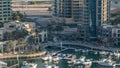 Luxury Dubai Marina canal with passing boats and promenade timelapse, Dubai, United Arab Emirates