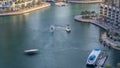 Luxury Dubai Marina canal with passing boats and promenade timelapse, Dubai, United Arab Emirates