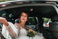 Luxury elegant wedding couple holding hands in stylish black car . gorgeous bride and handsome groom in retro style Royalty Free Stock Photo