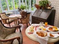 Luxury English Breakfast on a table with interior brown armchairs with decoration room