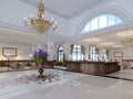 Luxury entrance in classic hotel with a large bouquet of flowers and a large golden chandelier Royalty Free Stock Photo