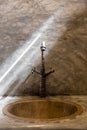 Luxury faucet with golden sink on the raw concrete counter in vintage bathroom. Line of sunlight hit the classic water tap Royalty Free Stock Photo