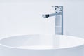 Luxury faucet mixer and white towel on a white sink in a beautiful gray bathroom. Sanitary prevention antivirus concept