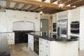 Luxury Fitted Kitchen In House With Beamed Ceiling Royalty Free Stock Photo