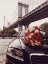 Luxury flower bouquet and limousine car service for romantic date in the city Royalty Free Stock Photo