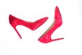 Luxury footwear concept. Footwear with thin high heels, stiletto shoes, top view. Shoes made out of red suede on white Royalty Free Stock Photo