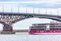 Luxury four-deck river cruise ship `Mustai Karim` on the Volga River. Automobile bridge between the cities of Saratov and Engels