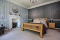 Luxury furnished bedroom with panelled walls