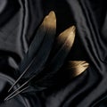 Luxury gilded gold golden black swan feather on silk cloth background