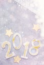 Luxury glitter numbers 2018 in a row with keyboard and presents under snow on grey concrete background