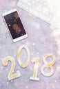 Luxury glowing numbers 2018 with cell phone and keyboard under snow on grey background Royalty Free Stock Photo