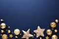 Luxury Gold Christmas decorations on dark blue background. Frame of golden Xmas baubles, stars, confetti Royalty Free Stock Photo